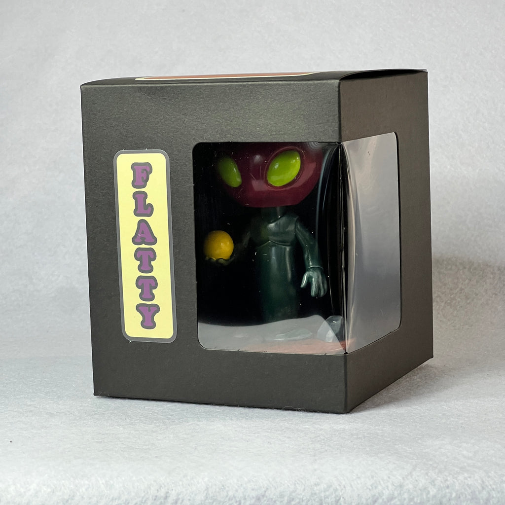 Toy figure in a black box with 'Platty' label on a white background